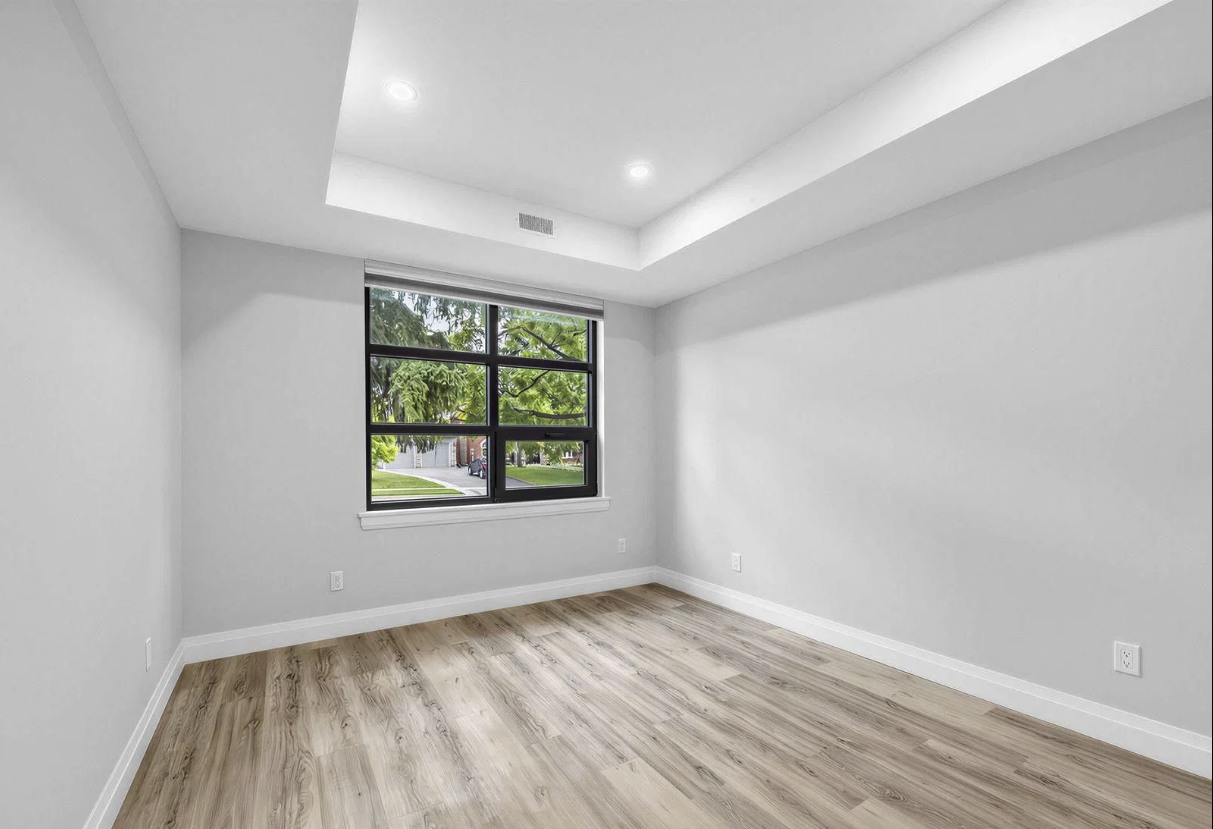 Bedroom with black-framed window