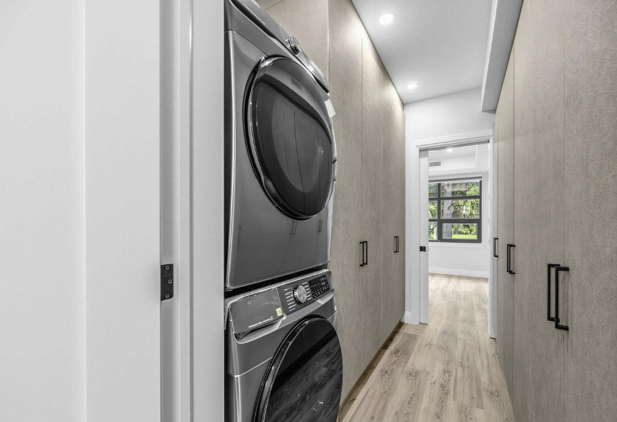 Stacked washer and dryer in hallway alcove