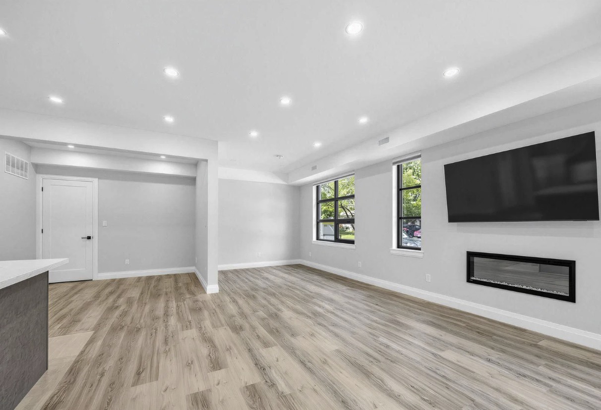 Living room with linear fireplace and TV wall